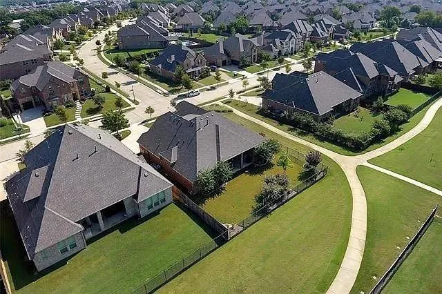 an aerial view of a house with a swimming pool