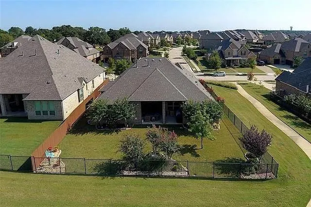 an aerial view of a house with a garden and lake view
