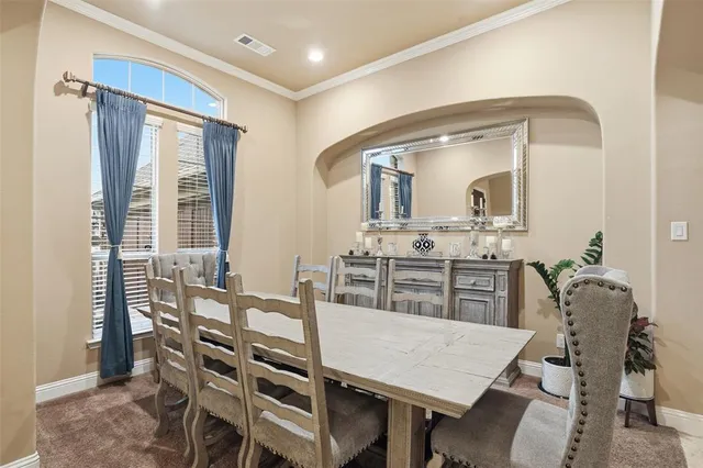 a view of a dining room with furniture and window