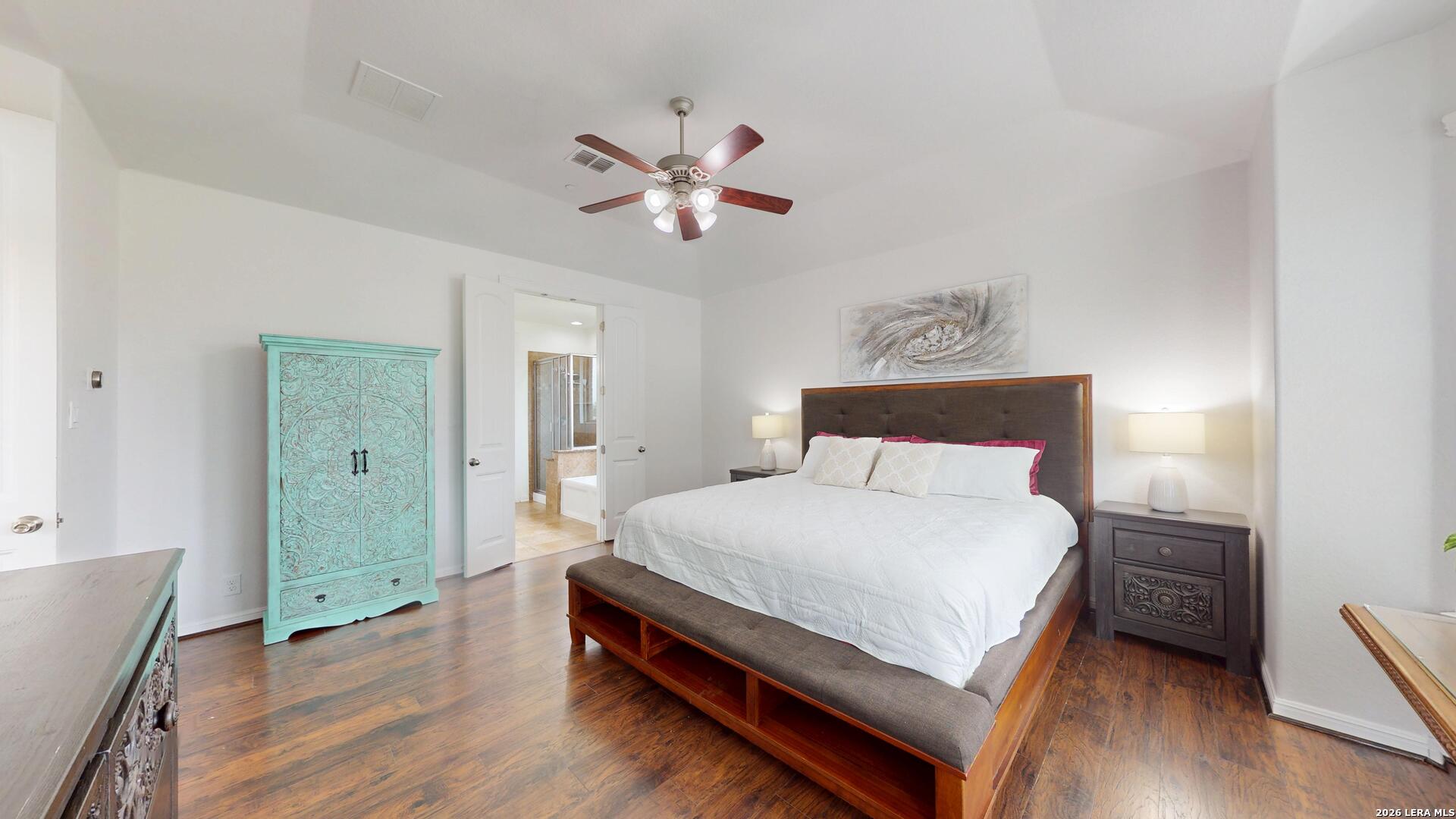 10111 Shallow Bank Converse, TX 78109 - Photo 44 of 65 a bedroom with a bed and a chandelier
