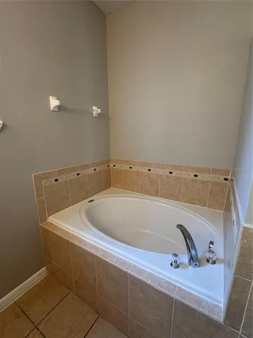 a view of an empty room and a ceiling fan