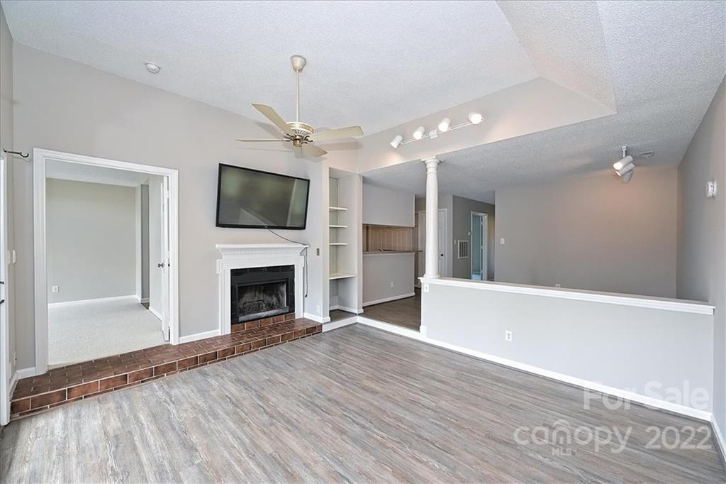 226 Queens Road, Unit 78 Charlotte, NC 28204 - Photo 16 of 32 a view of a livingroom with a fireplace wooden floor and window
