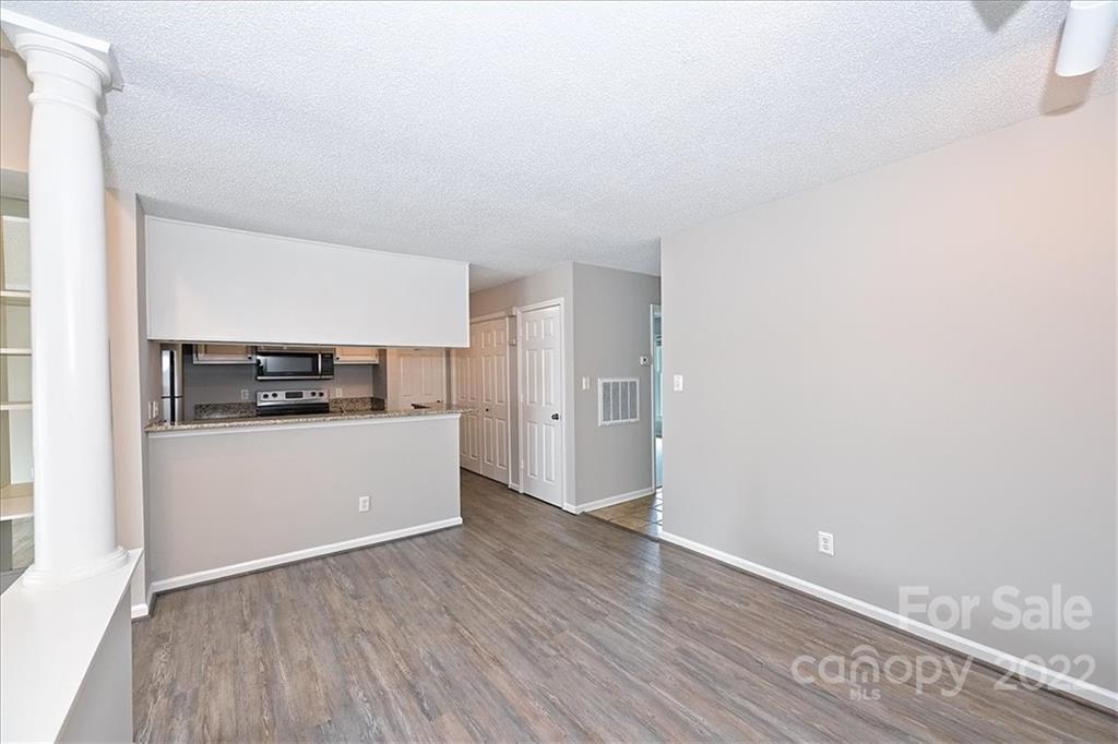 226 Queens Road, Unit 78 Charlotte, NC 28204 - Photo 6 of 32 a view of a kitchen with a sink and dishwasher stove top oven with wooden floor