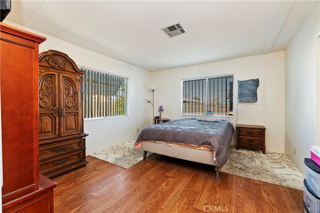 1630 Sonora Drive Hemet, CA 92543 - Photo 12 of 22 a bedroom with a bed and wooden floor