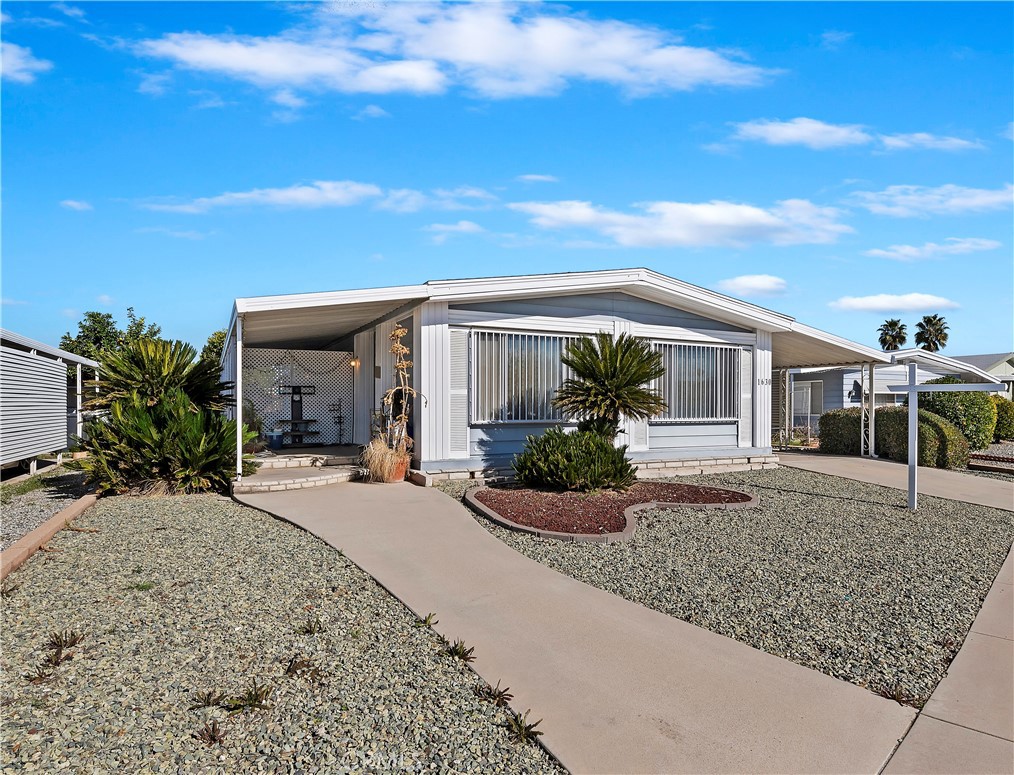 1630 Sonora Drive Hemet, CA 92543 - Photo 3 of 22 a front view of house with small garden in front of it
