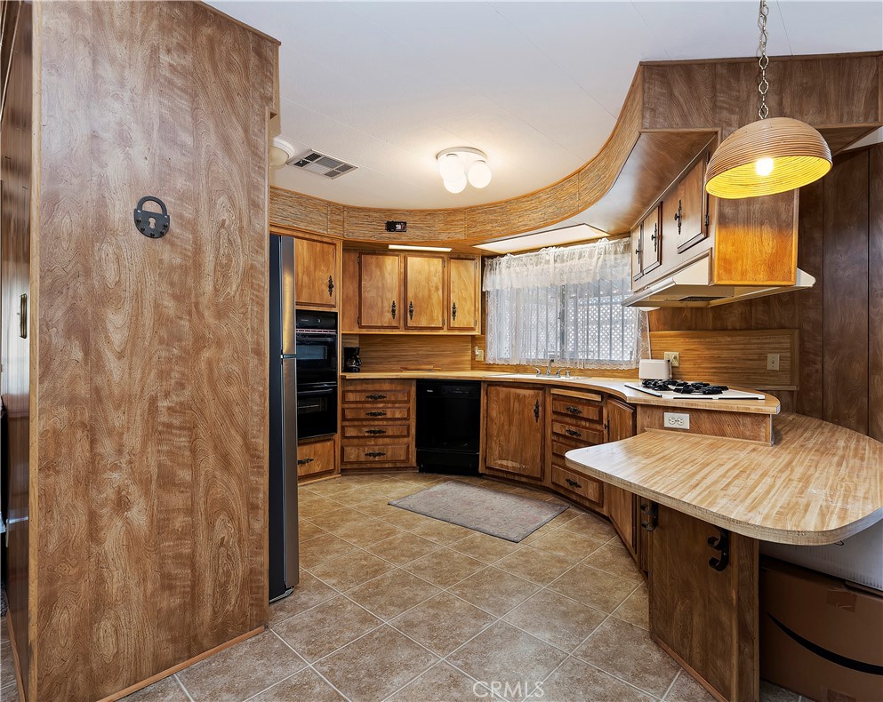 1630 Sonora Drive Hemet, CA 92543 - Photo 7 of 22 a kitchen with stainless steel appliances a stove a sink and a refrigerator