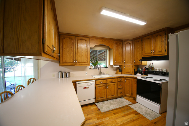 1612 East 450 South Springville, UT 84663 - Photo 18 of 48 Kitchen featuring extensive wood cabinetry, wood-finish flooring, and white countertops