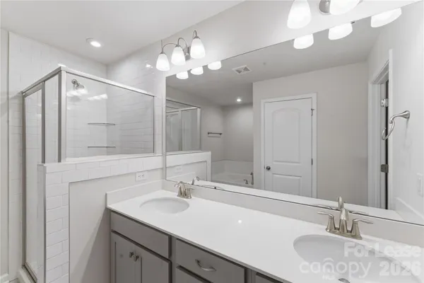 a spacious bathroom with a double vanity sink mirror and double