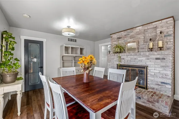a dining room with furniture and wooden floor