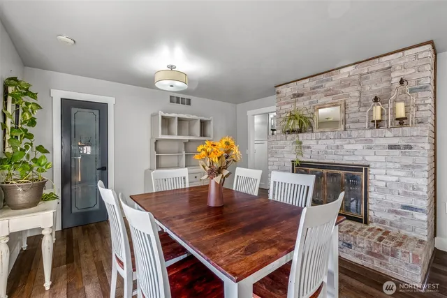 a dining room with furniture and wooden floor