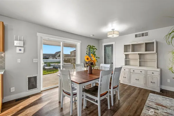 a dining room with furniture and wooden floor