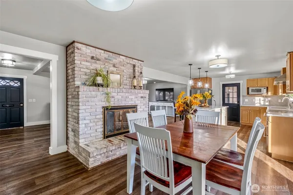 a dining room with furniture and wooden floor
