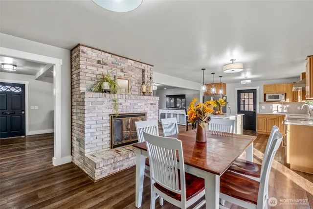 a dining room with furniture and wooden floor