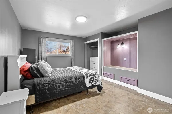 a bedroom with a bed and window