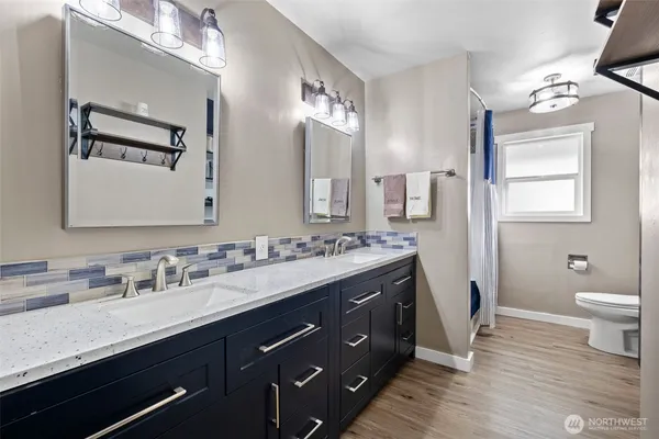 a bathroom with a double vanity sink and a mirror