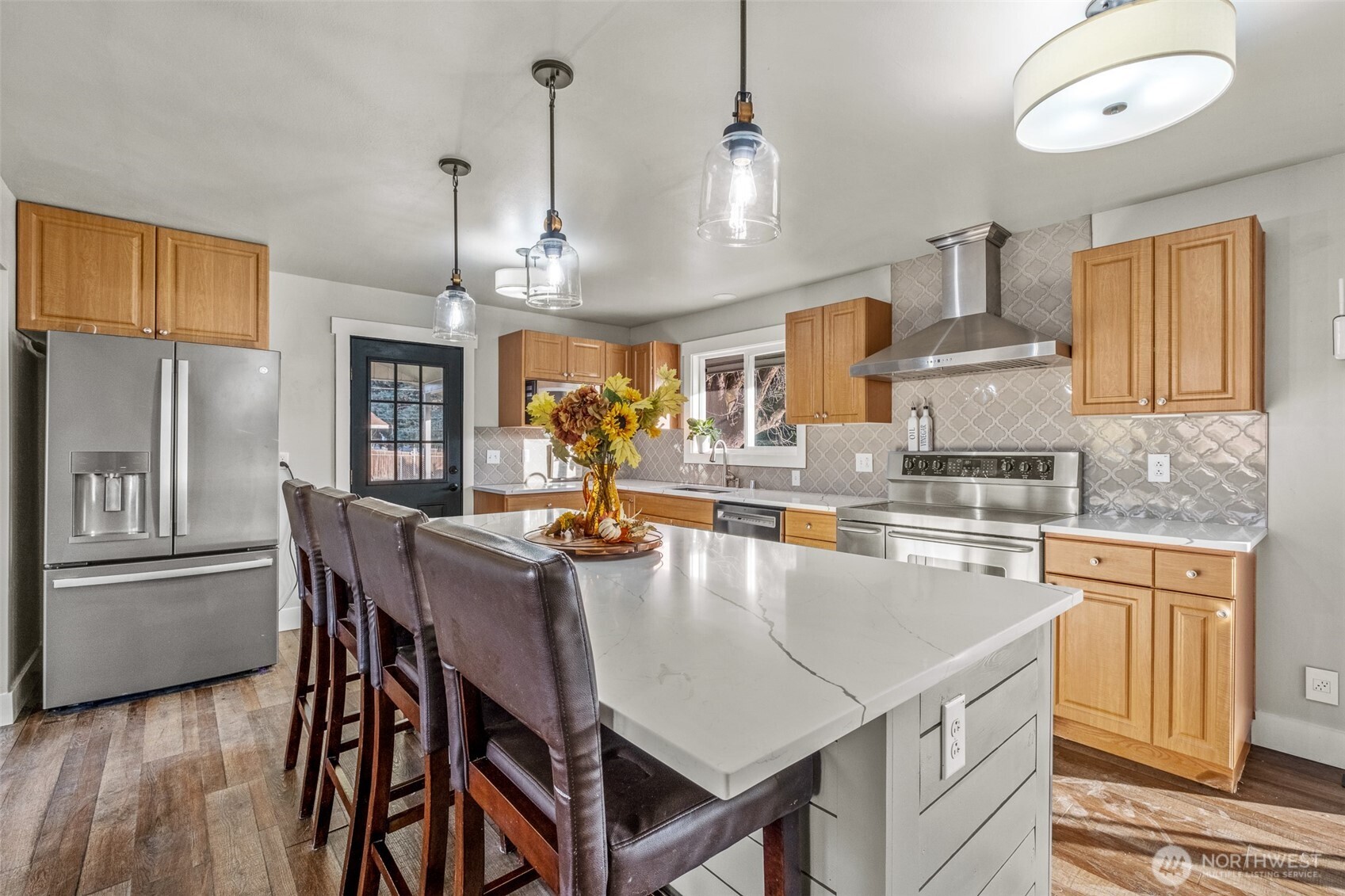 608 H Street Southeast Quincy, WA 98848 - Photo 9 of 32 a kitchen with stainless steel appliances granite countertop a kitchen island a stove a table and chairs in it