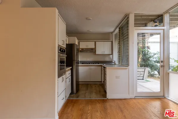 a kitchen with a refrigerator and a sink