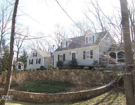 1285 Mill Hill Road Fairfield, CT 06890 - Photo 1 of 1 a view of a white house next to a yard with large trees
