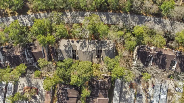 a backyard of a building with lots of trees