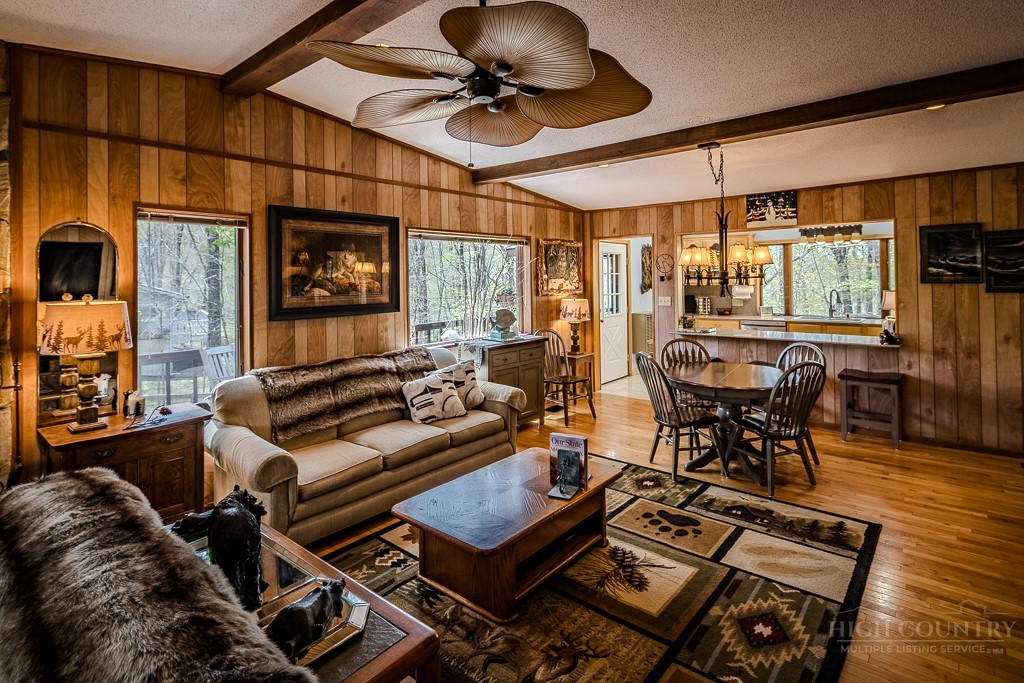 103-105 Upper Grouse Ridge Road Beech Mountain, NC 28604 - Photo 13 of 48 a living room with furniture a flat screen tv and a table
