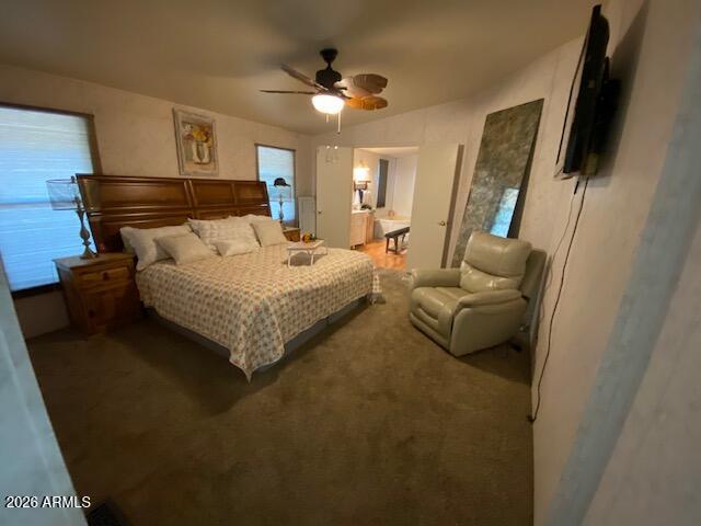 21301 West Dove Valley Road Wittmann, AZ 85361 - Photo 11 of 17 a bedroom with a bed a couch and a flat tv screen on the dresser