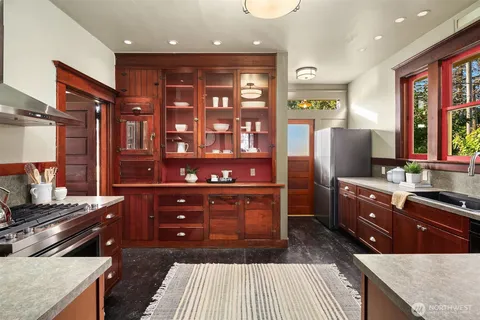 a kitchen with stainless steel appliances granite countertop a stove a sink and a refrigerator