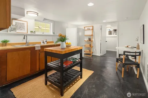 a living room with furniture a dining table and paintings on the wall