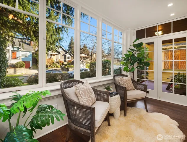a bedroom with a bed a window and potted plant on the table