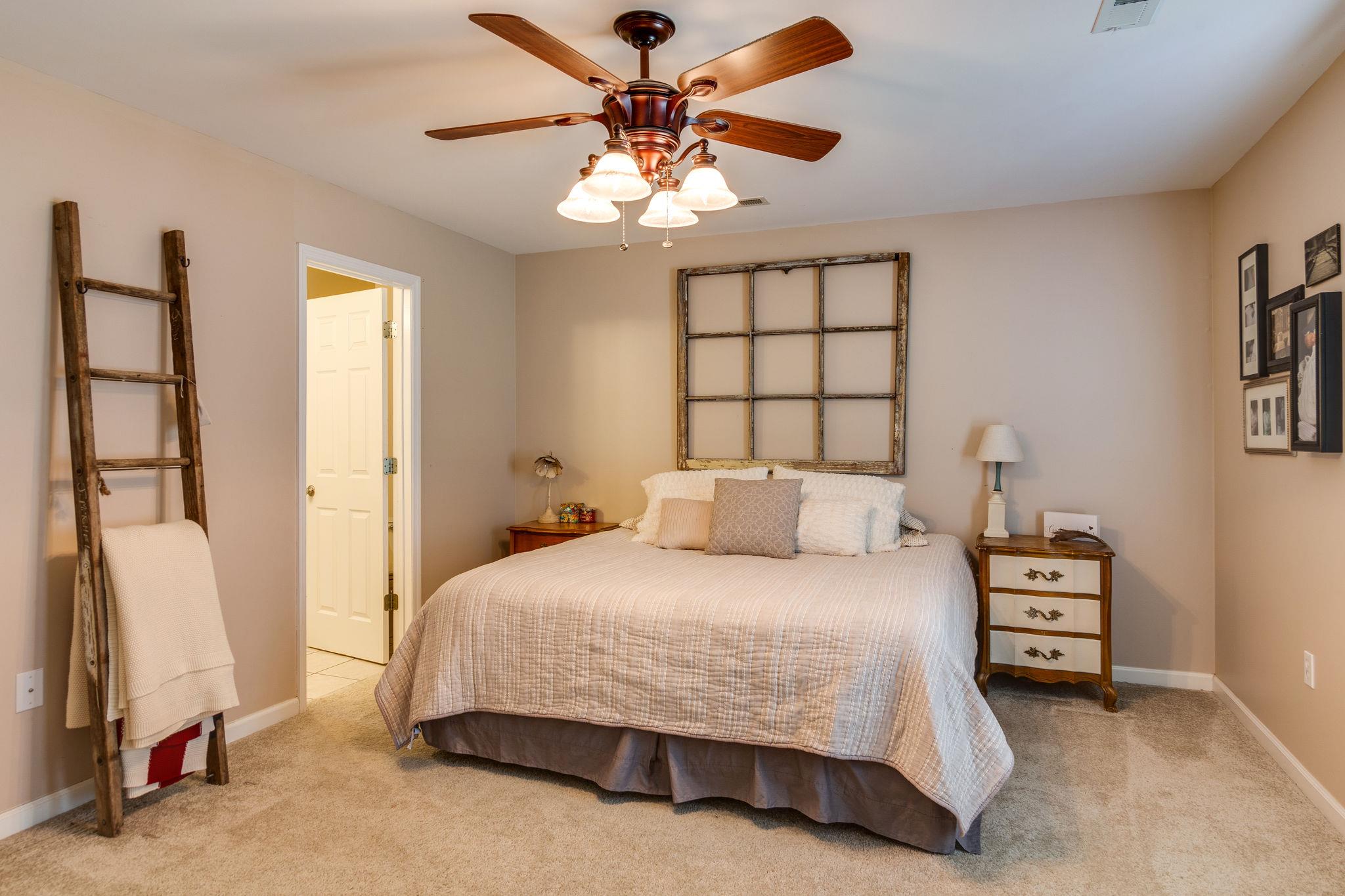 1675 Center Star Road Columbia, TN 38401 - Photo 14 of 21 a bedroom with a bed and a chandelier
