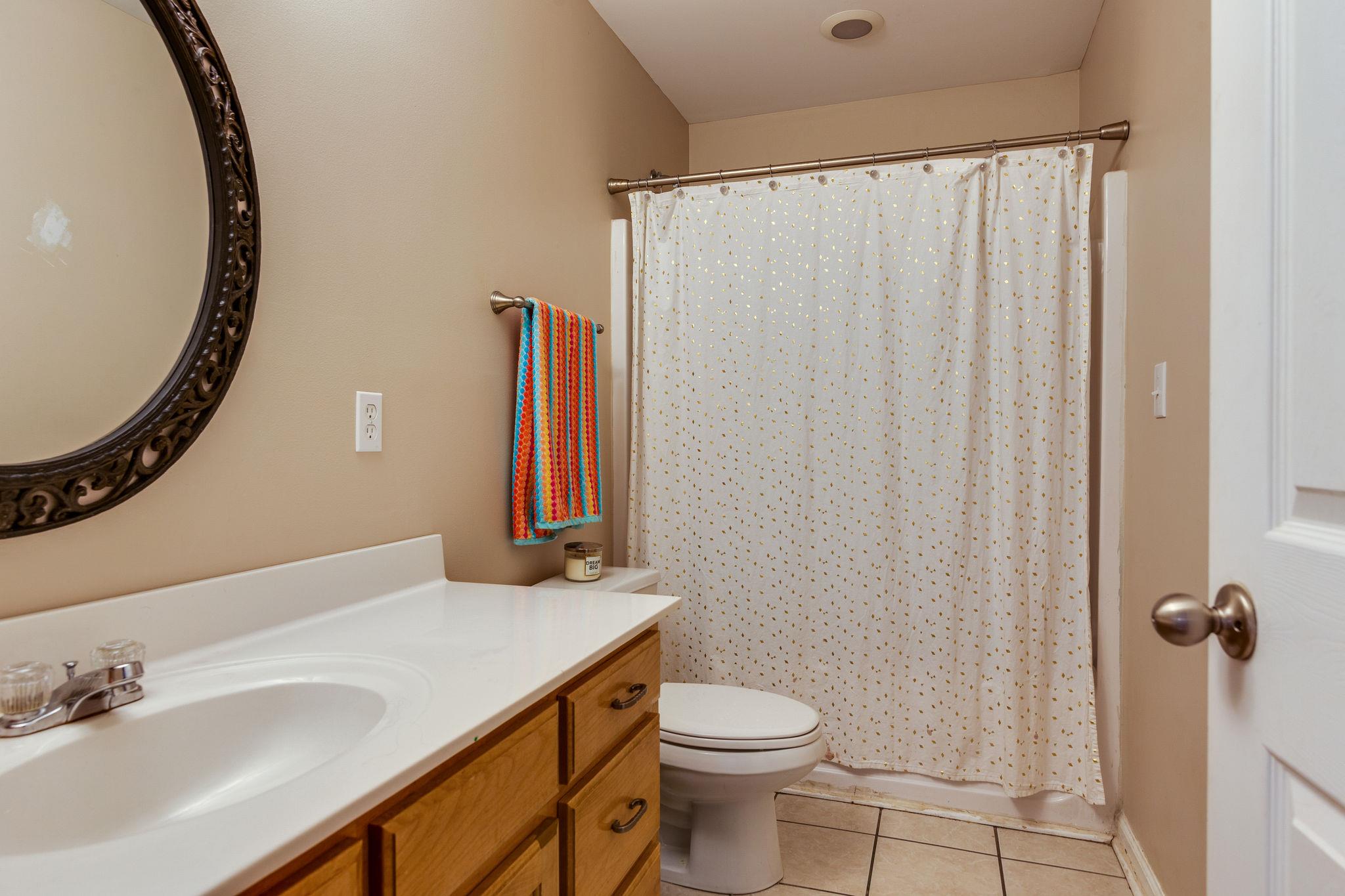 1675 Center Star Road Columbia, TN 38401 - Photo 15 of 21 a bathroom with a sink a toilet and shower curtain