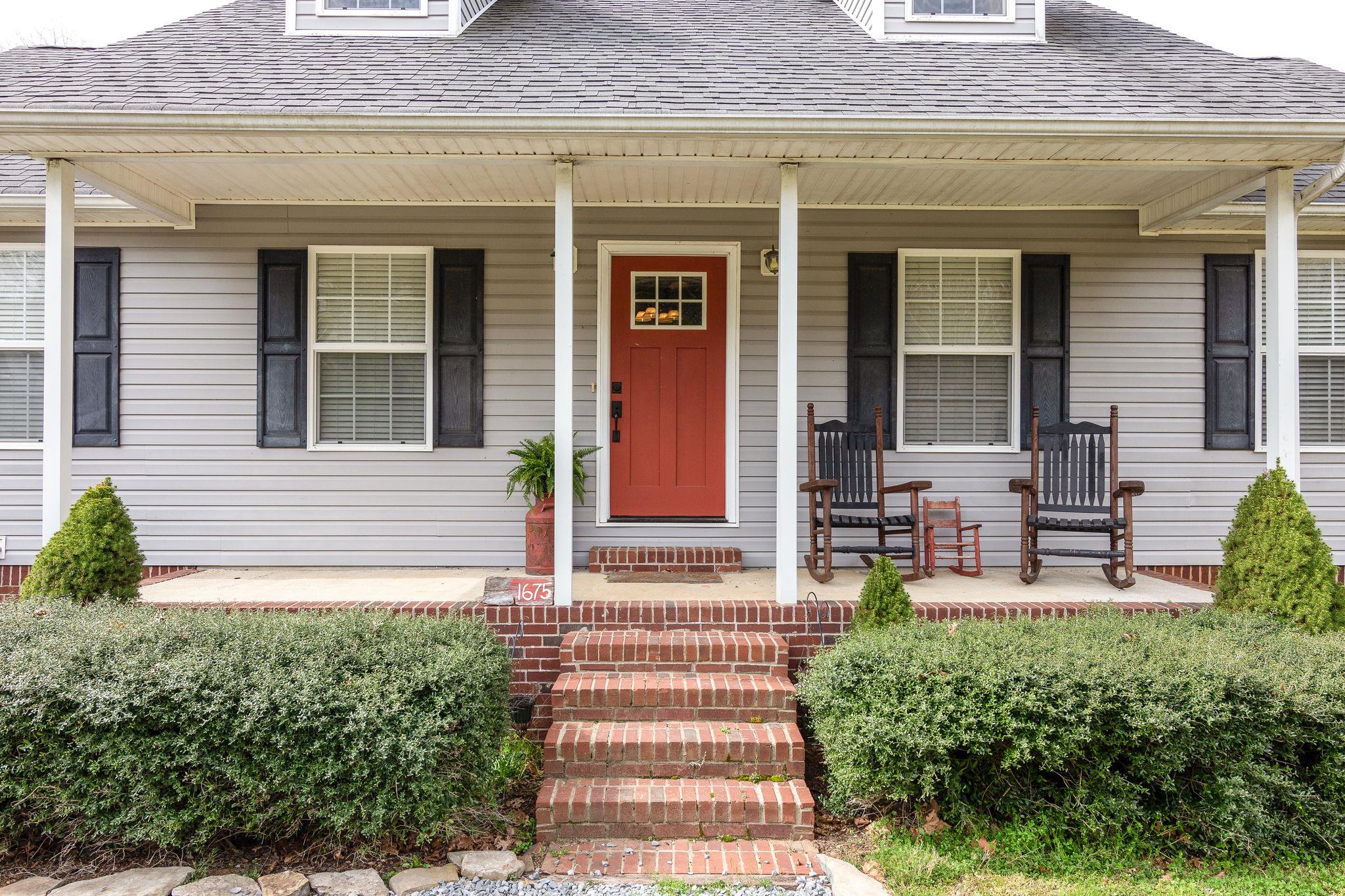 1675 Center Star Road Columbia, TN 38401 - Photo 3 of 21 front view of a house with a bench and potted plants