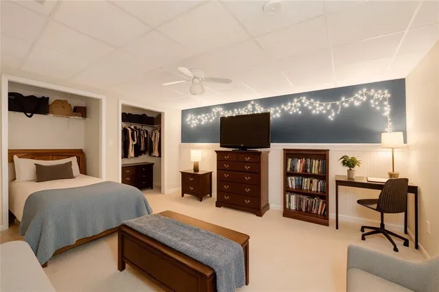 a bedroom with furniture and a flat screen tv