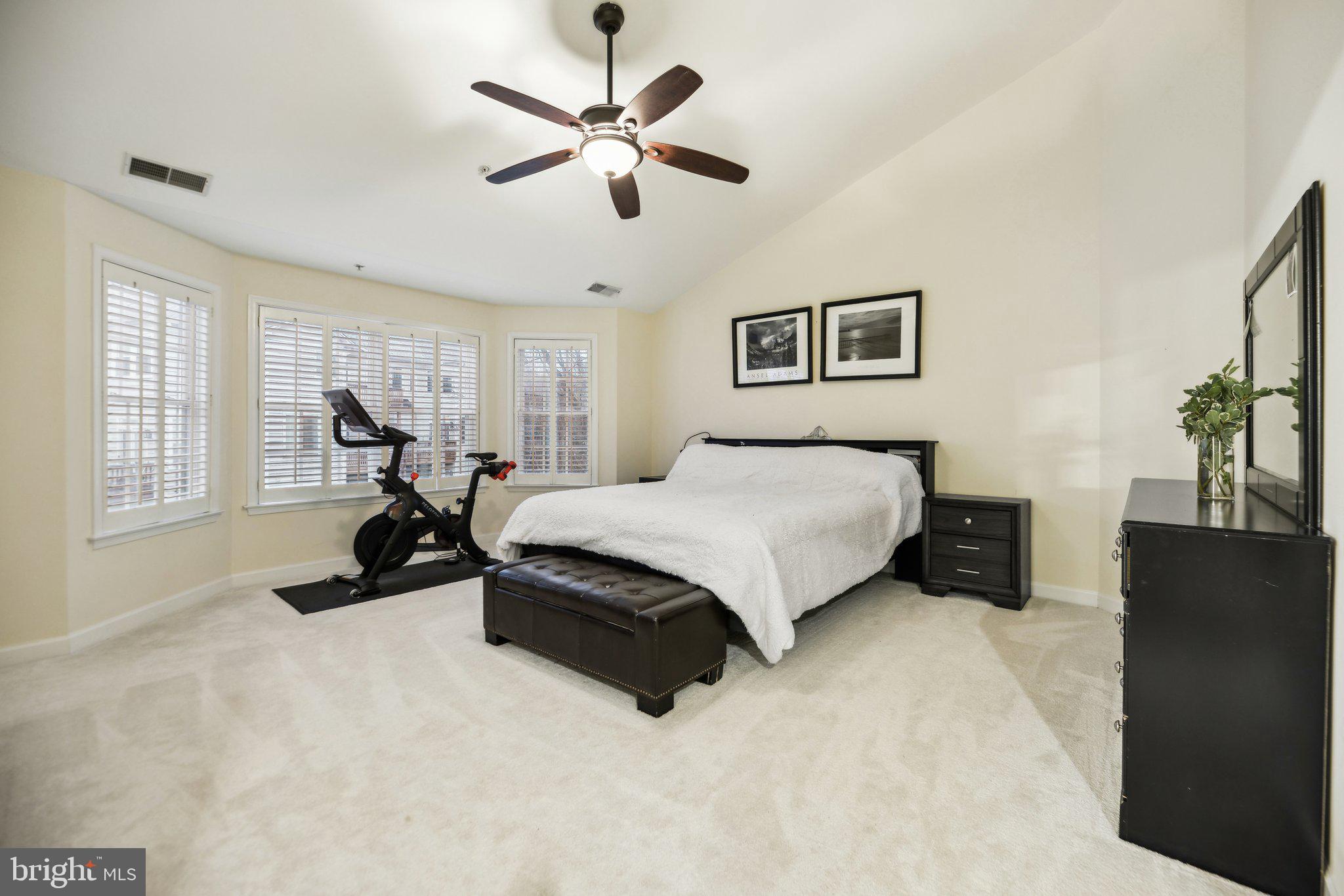 47753 Ramshead Terrace Sterling, VA 20165 - Photo 16 of 37 a spacious bedroom with a bed and a large window