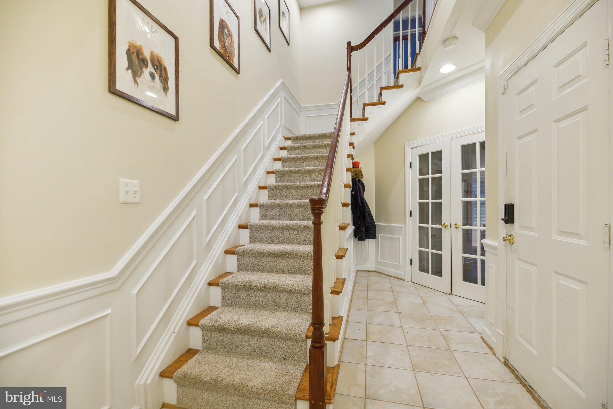 47753 Ramshead Terrace Sterling, VA 20165 - Photo 2 of 37 a view of staircase with lots of frames on wall and a large window