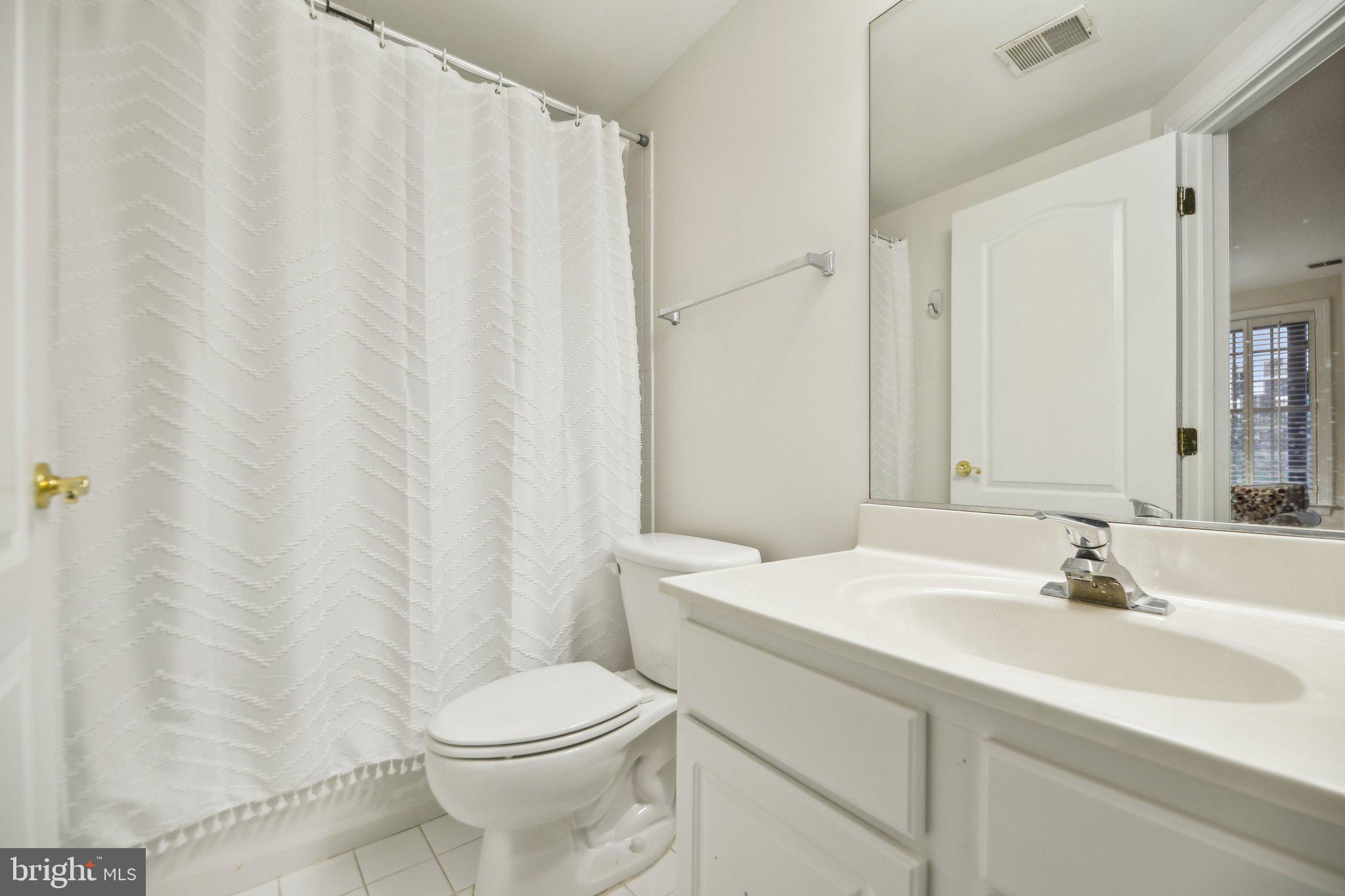 47753 Ramshead Terrace Sterling, VA 20165 - Photo 28 of 37 a bathroom with a sink a toilet and a mirror