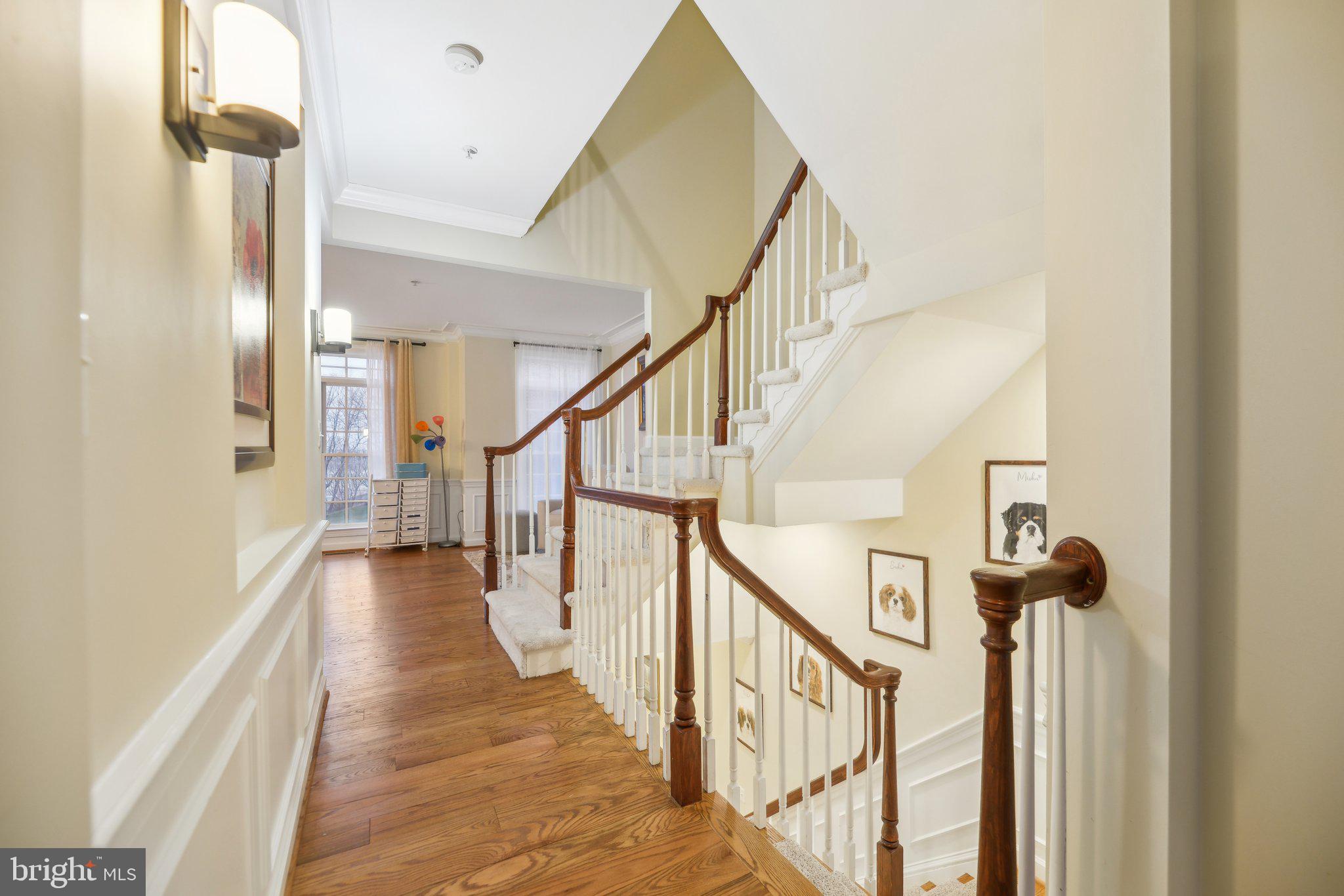 47753 Ramshead Terrace Sterling, VA 20165 - Photo 3 of 37 a view of a hallway with wooden floor and staircase