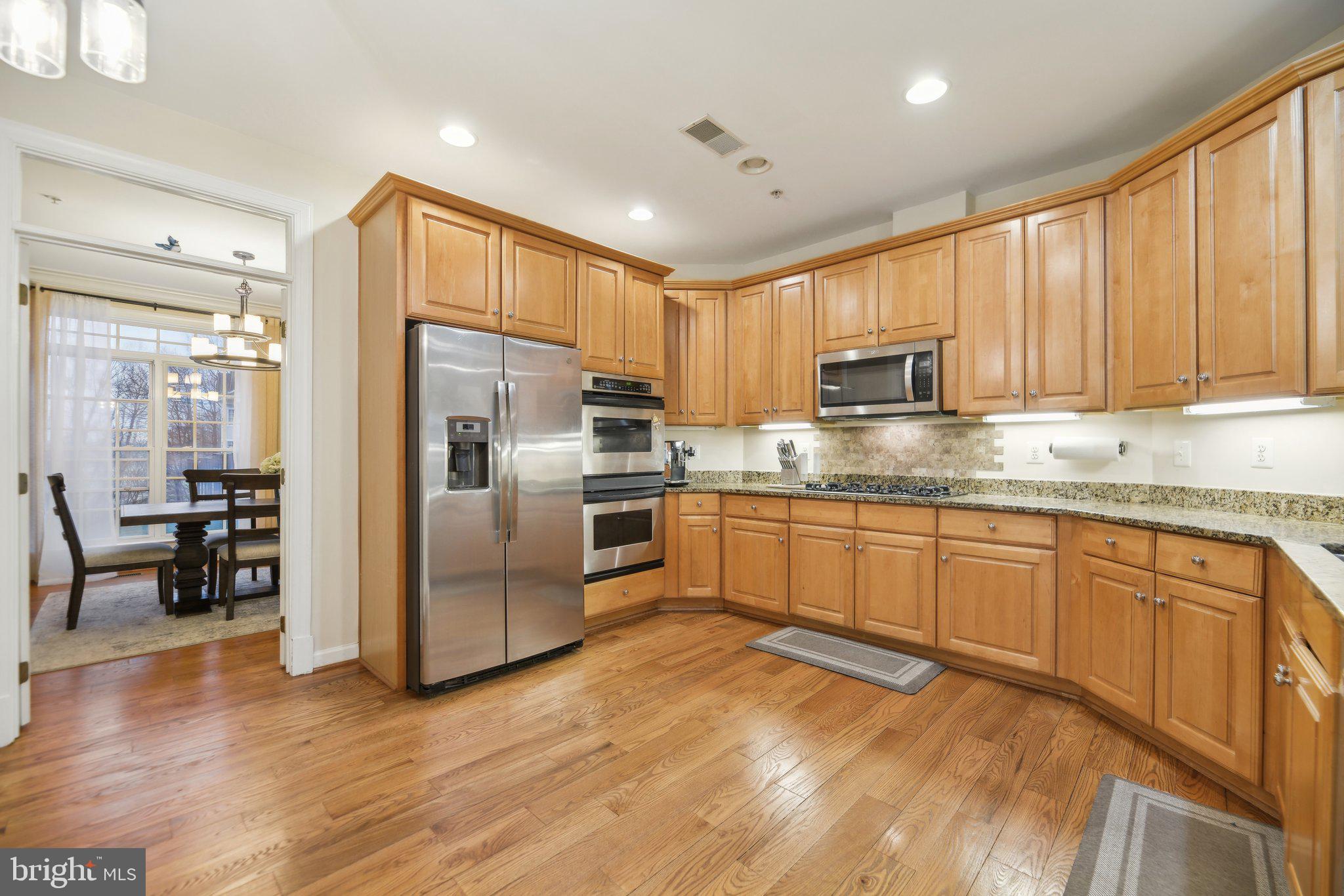 47753 Ramshead Terrace Sterling, VA 20165 - Photo 7 of 37 a kitchen with stainless steel appliances granite countertop a refrigerator a stove top oven a sink and dishwasher
