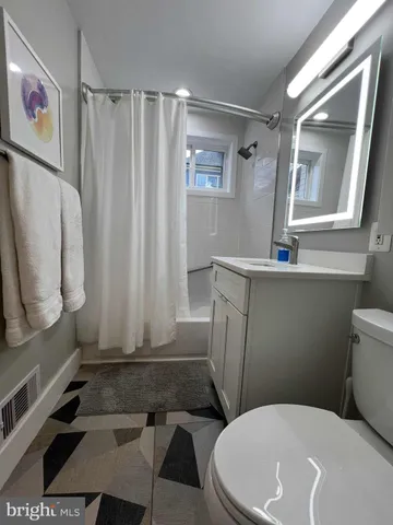 a bathroom with a toilet a sink and bathtub