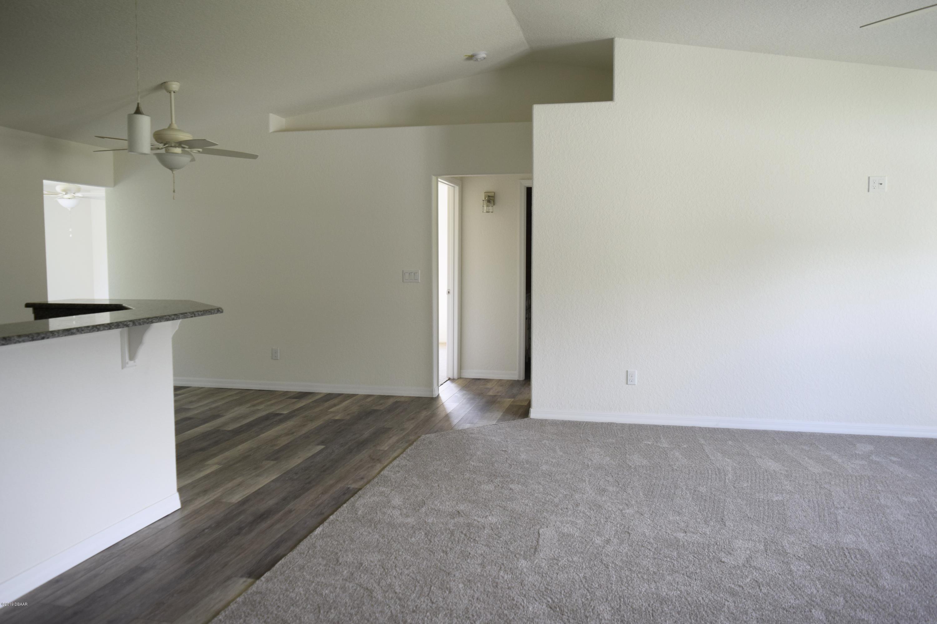 3129 Pine Tree Drive Edgewater, FL 32141 - Photo 15 of 22 living room to spare bedrooms