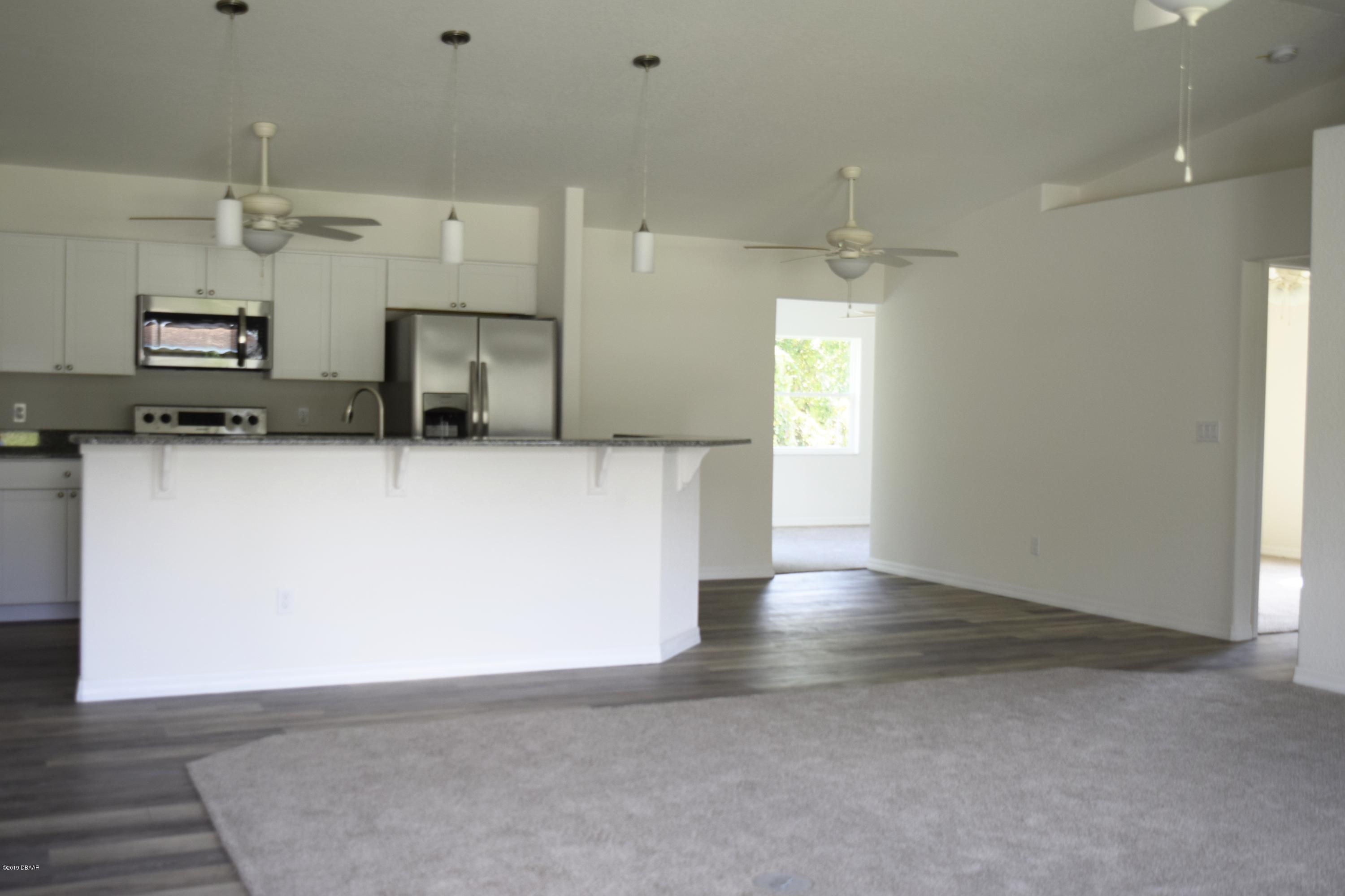 3129 Pine Tree Drive Edgewater, FL 32141 - Photo 5 of 22 living room to family room