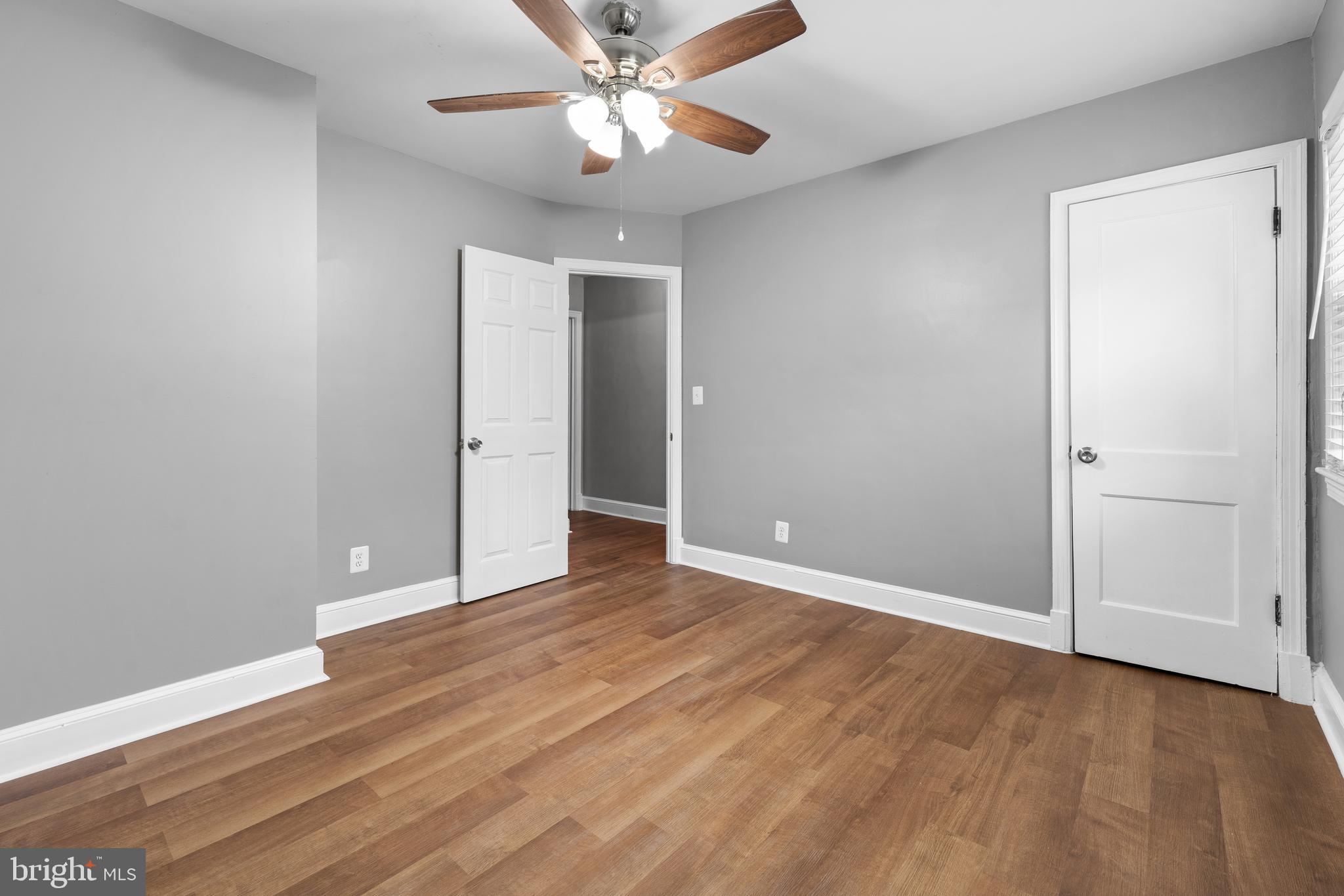 1613 R Street Southeast Washington, DC 20020 - Photo 11 of 34 an empty room with wooden floor chandelier fan and closet area