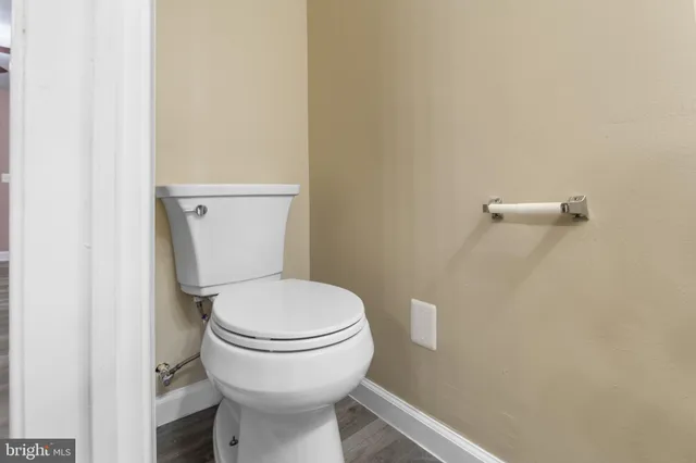 a white toilet sitting next to a white sink