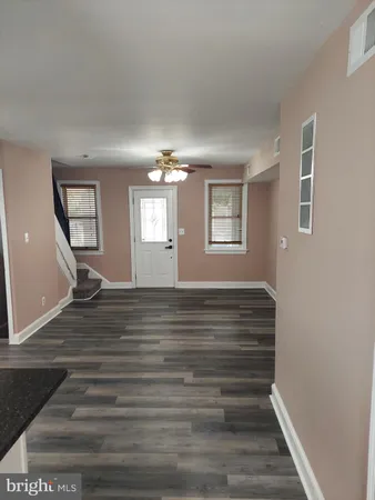 a view of empty room with window and fireplace