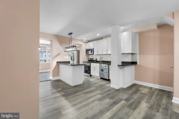 a kitchen with white cabinets and white appliances
