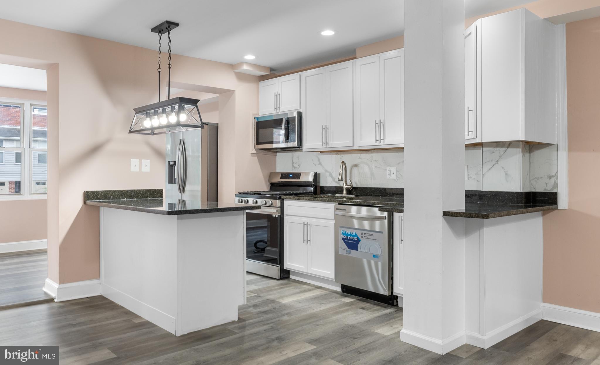 1613 R Street Southeast Washington, DC 20020 - Photo 8 of 34 a kitchen with stainless steel appliances granite countertop a refrigerator a sink dishwasher a stove and white cabinets with wooden floor
