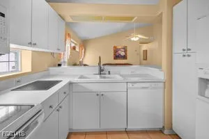 a kitchen with sink cabinets and a window