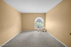 a view of empty room with a fireplace