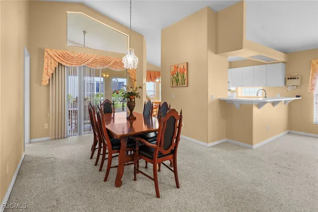 a view of a dining room with furniture and a window