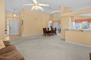 a view of a livingroom with furniture and a fan