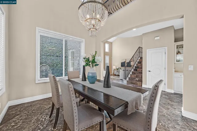 a kitchen with a sink stove and chairs